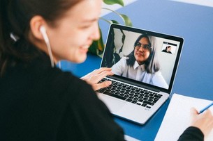 Girl in front of laptop having a virtual meeting