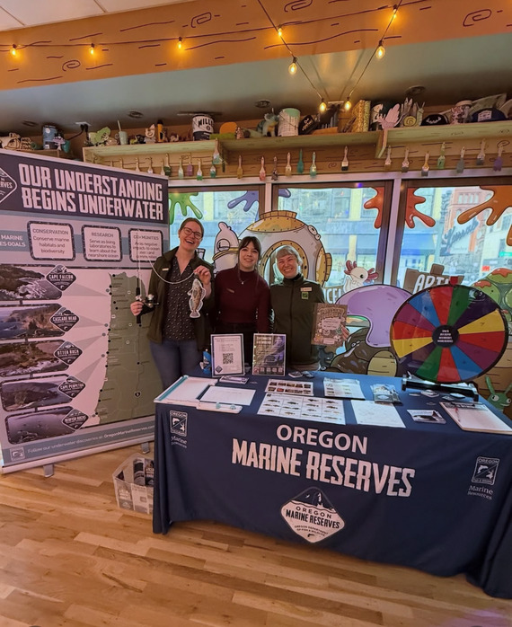 Three Marine Reserves team members table at Marine Reserves Takeover at the Portland Aquarium. 