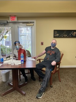 Dave is wearing a mask and an Oregon State t-shirt with his sleeve rolled up. A 