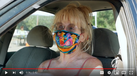 Woman in glasses with multi-colored mask