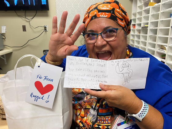 Photo of Tamar Solinger, staffer in the emergency department at St. Vincent Hospital, with the kindness kit she received from Positive Charge PDX.