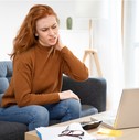 woman-with-neck-ache-sitting-with-laptop