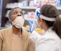 image of woman getting a COVID-19 test at a pharmacy
