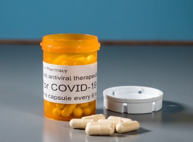 Image: A COVID-19 prescription bottle with pills