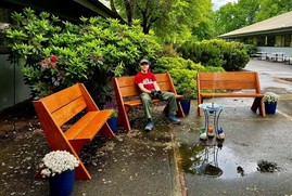 Chase Krossman sitting in the gardens he helped build in District 16 with his Eagle Scout team to honor Child Welfare workers who have passed