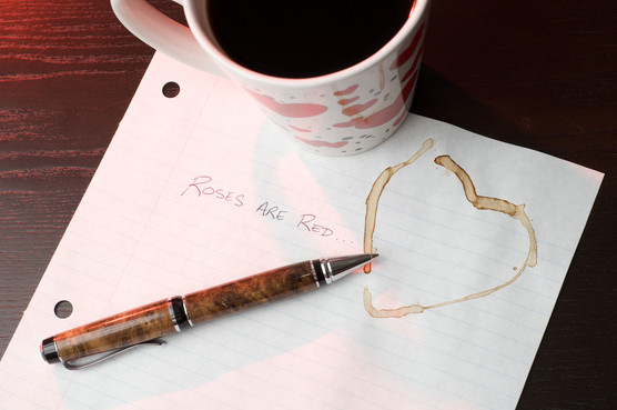 photo of a mug of coffee and piece of paper with poetry on it