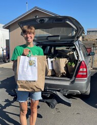 photo of woman holding bag of food