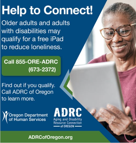 photo of smiling Black woman with glasses holding a tablet