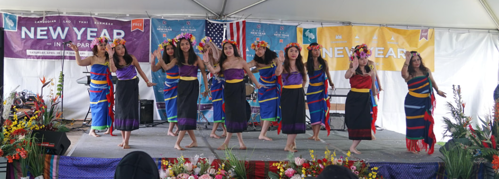 women traditional dancing on stage with flowers on their heads