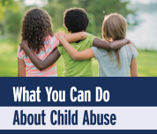 three children facing away with hands on each others shoulders