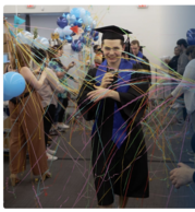 young man with graduation cap and gown walking through celebration