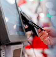 hand putting a card into a bank machine