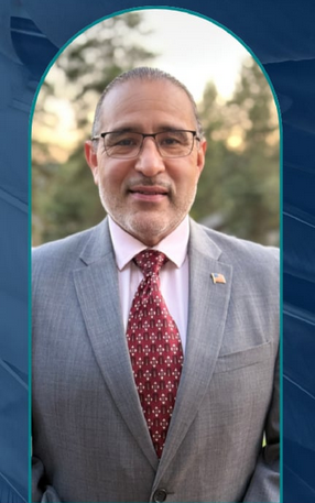 Smiling man in suit with glasses and beard