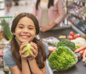 smiling girl holding vegetable