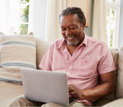 smiling older man in front of computer