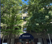 photo of front entrance to ODHS brick multilevel building with trees