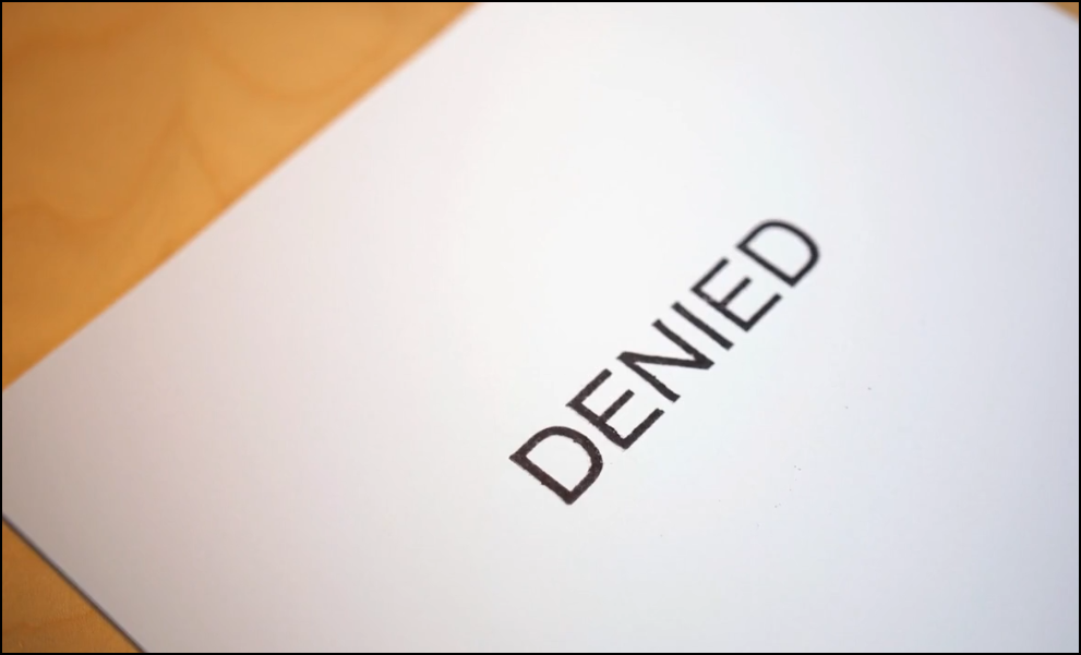 A sheet of paper with the worded denied on it.