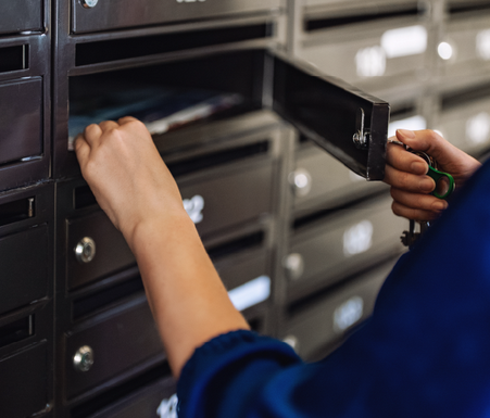 hand reaching into a post office box