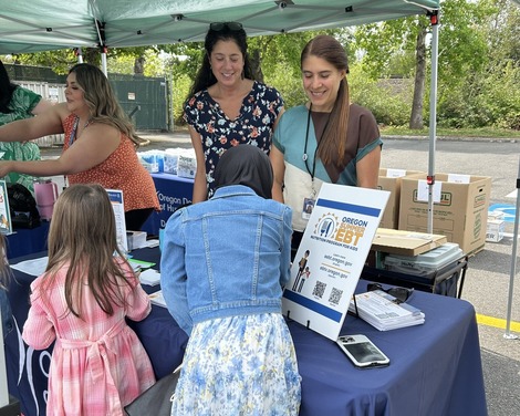 ODHS employees help children at a booth for Summer EBT
