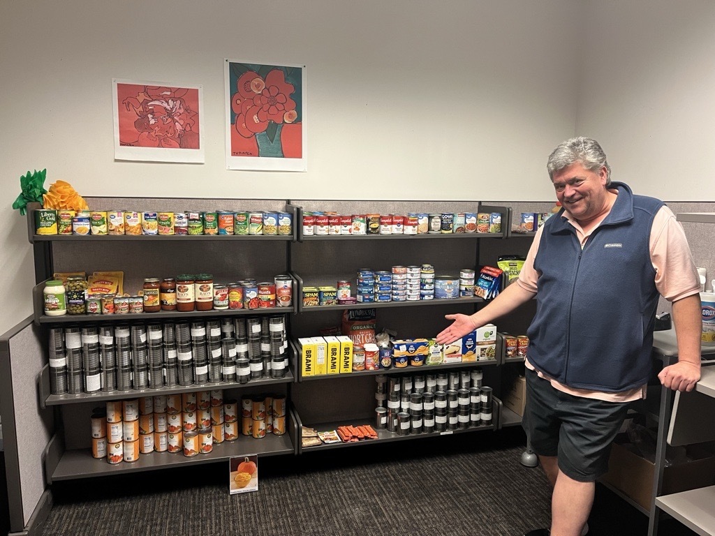 An ODHS employee poses with all the food donations he personally gathered to help people in need during the shutdown