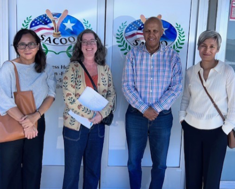 4 people smiling in front of the African Imperial restaurant