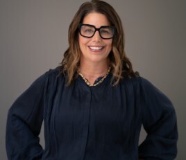 photo of smiling woman with shoulder-length brown hair
