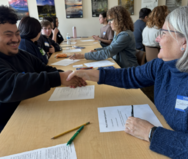 student and teacher shaking hands