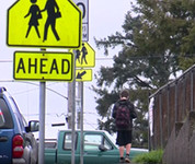 Safe routes to school boy walking on sidewalk