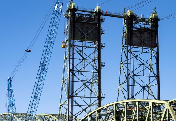 Crews are lifted to the top of the tower to prepare the bridge for the September maintenance work. 