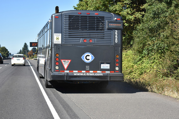 A bus traveling on the shoulder.