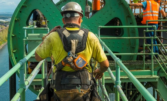 A worker faces the sheave