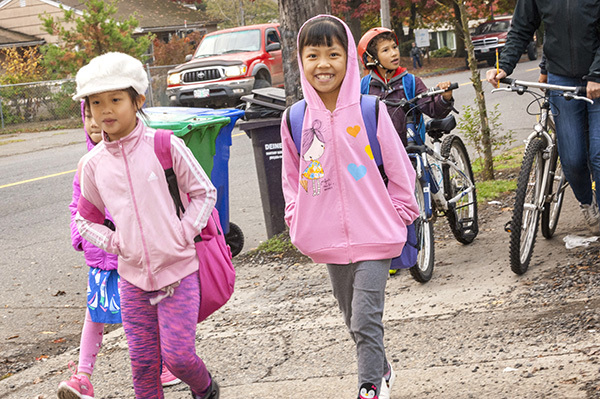 child walking bicycles