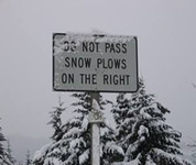 Sign: Do not pass snow plows on the right