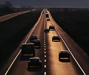 Highway with vehicles driving at dusk
