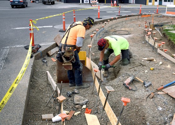 crews form a new curb ramp readying it for a concrete pourd