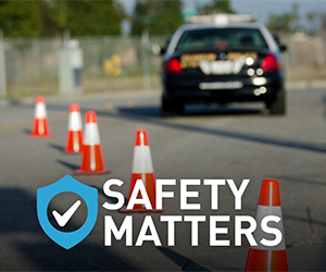 Text: safety matters. Image: police vehicle on roadway with orange traffic cones behind it.