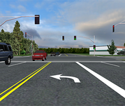 Roadway viewpoint of a left turning driver at a traffic light with a permitted left turn.
