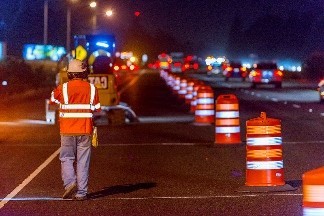 Construction worker walking on highway