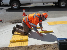 photo showing ODOT staff measuring curb ramp