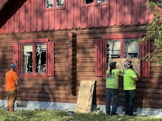 Contractors help board up windows damaged by storm
