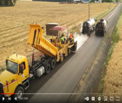Work zone chip seal operation on the roadway.