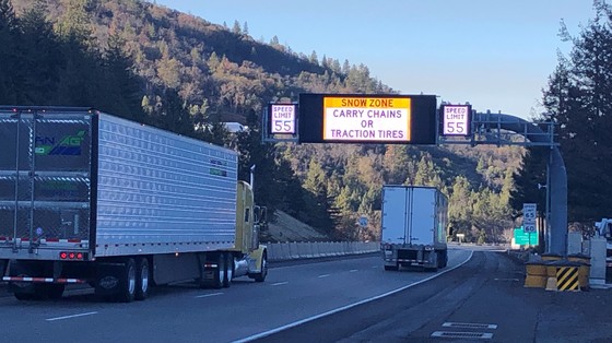 Trucks pass a new electronic variable speed sign on Interstate 5 northbound on Siskiyou Summit, south of Ashland.