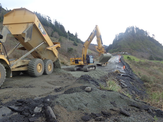 Heavy equipment builds a temporary lane through the U.S. 101 landslide