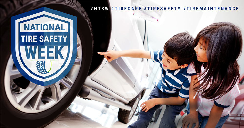 Children pointing at a tire on a vehicle. National Tire Safety Week.