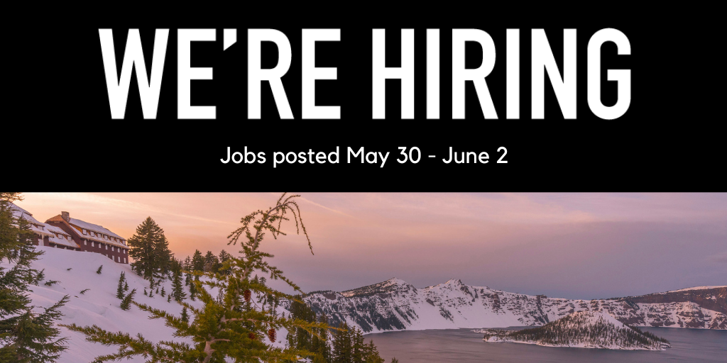 Photo of Crater Lake with the lodge on the top left and snow blanketing the ground. 