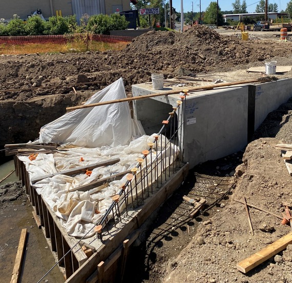 The concrete boxes are placed in a chain and placed under the highway. 