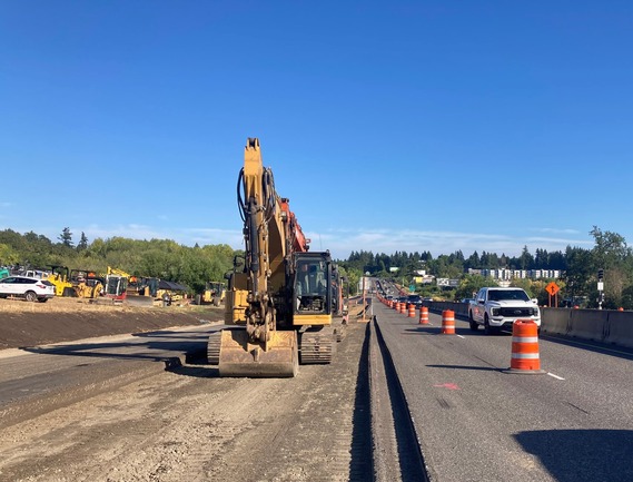 An excavator digs out the old pavement that will be rebuilt.