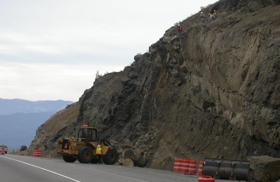 Crews work to remove large boulders on steep hillside above Interstate 5.