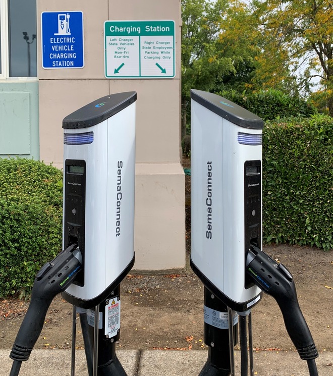 Two level 2 EV chargers in a parking lot