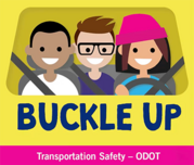 Buckle up. Image shows three people smiling in a vehicle with seat belts.